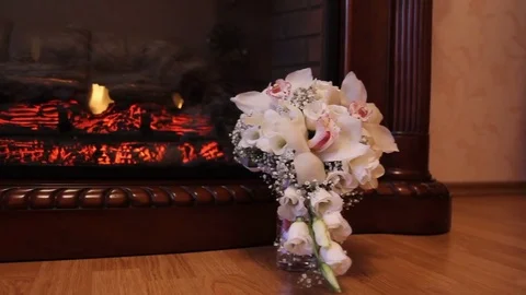 Flowers infront of burning fireplace - a dolly shot Stock Footage
