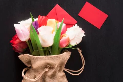 Flowers in a jute sack and a message card Stock Photos