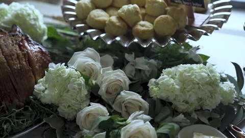 Flowers laid out between dishes of food at wedding party 動画素材 142028016