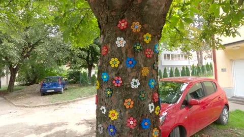 Flowers made of plastic plugs on a tree Stock Footage 140374722