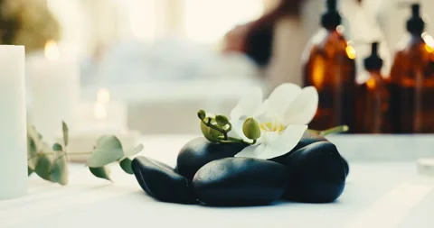 Flowers, rocks and spa for relax, aromatherapy candle or natural wellness for Stock Footage 345574856