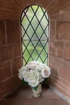 Flowers set in a chruch window Stock Photos