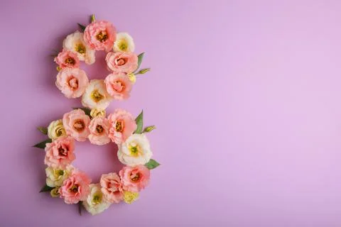 Flowers in the shape of number 8 on a colored background with place for text Stock Photos