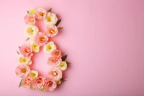 Flowers in the shape of number 8 on a colored background with place for text Stock Photos