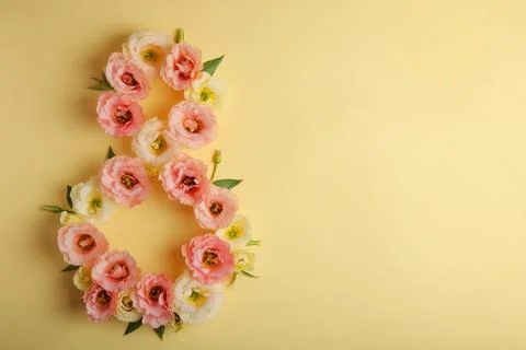 Flowers in the shape of number 8 on a colored background with place for text Stock Photos