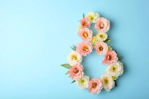 Flowers in the shape of number 8 on a colored background with place for text Stock Photos