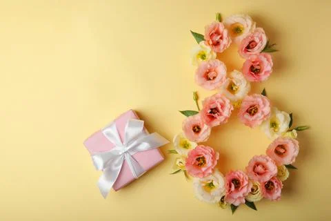 Flowers in the shape of number 8 on a colored background with place for text Stock Photos
