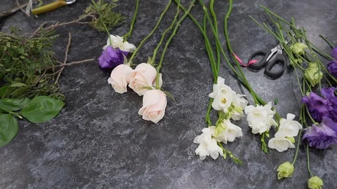 Flowers on a table for making a bouquet in a flower shop, closeup Stock Footage 123592069