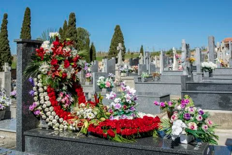 Flowers on the tomb in a graveyard Stock Photos