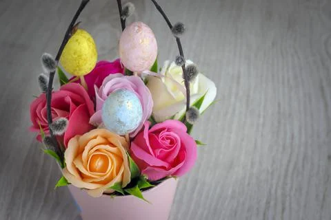 Flowers, willow twigs and easter eggs in as Easter gift on wooden background Stock-Fotos