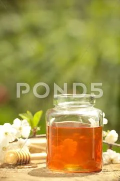Flowery honey in glass jar Stock Photos
