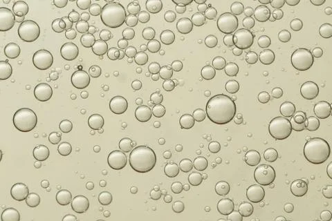 Flowing air bubbles soars over a golden background Stock Photos
