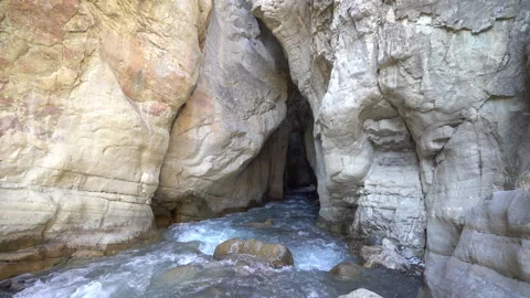 Flowing Alpine River Between Cliffs in Slow Motion Video stock 318899359