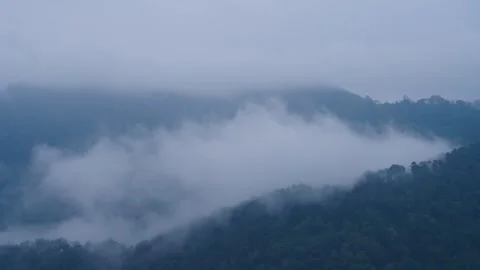 Flowing and tumbling clouds between valleys Stock Footage 313340918