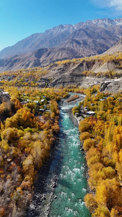 Flowing blue river framed by red leaves – vertical drone in Kargil. Stock Footage 310665354
