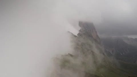 Flowing clouds gracefully enveloping a majestic mountain peak Video stock 289087619