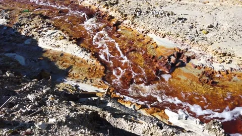 Flowing contaminated polluted mine water from a copper mine exploitation Stock Footage 220472938