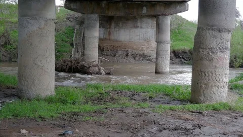 Flowing dirty Olt river under a concrete bridge Stock Footage 107894304