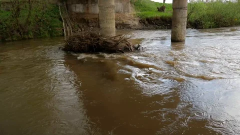 Flowing dirty Olt river under a concrete bridge Stock Footage 107894328