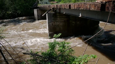 Flowing dirty Olt river under a concrete bridge Stock Footage 108648557