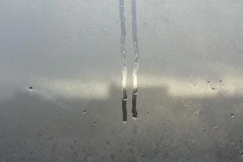 Flowing drops on the misted glass. Stock Photos