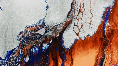 Flowing fluid glitter white orange paint motion Stock Footage 125918181