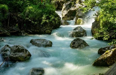 Flowing Forest Stream with Mountain Background Stock Photos