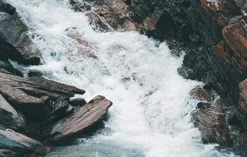 Flowing Forest Stream with Mountain Background Stock Photos