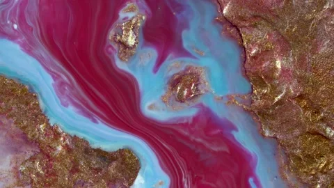 Flowing liquid paints over a golden surface Stock Footage 219633380