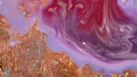 Flowing liquid paints over a golden surface Stock Footage 220767989