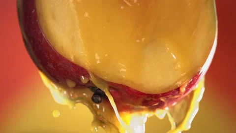 Flowing Mango Juice from half slide Mango , macro shot in slow motion Stock Footage 162298092