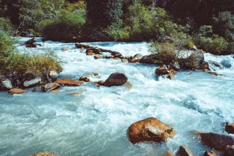 Flowing mountain river Stock Photos