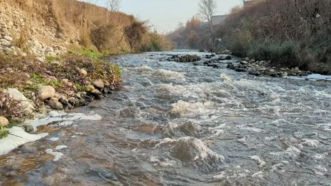 Flowing Polluted Drain Water with Garbage and Sewage Contamination Stock Footage 329147456