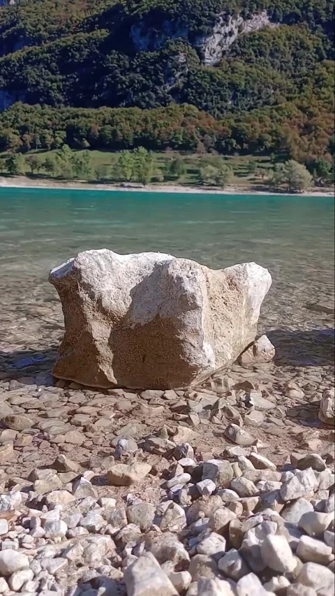 Flowing pristine pure water lake mountain stones and rock peace Stock Footage 255611694