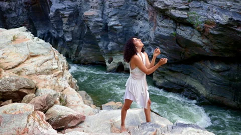 A Flowing River and Graceful Movement: A Dancer Expresses Freedom Amidst Natures Stock Footage 314280564