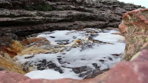 Flowing river between rocks in a little waterfall Stock Footage 168649329