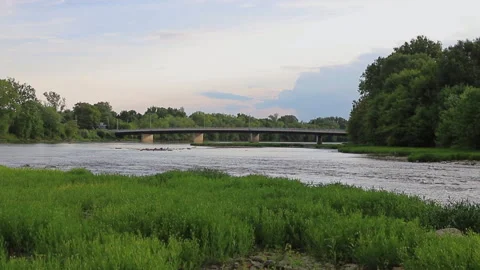 Flowing river with bridge in the background Stock Footage 142403136