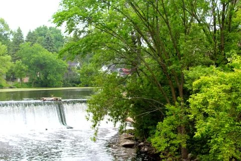 A flowing river with a dam. Stock Photos
