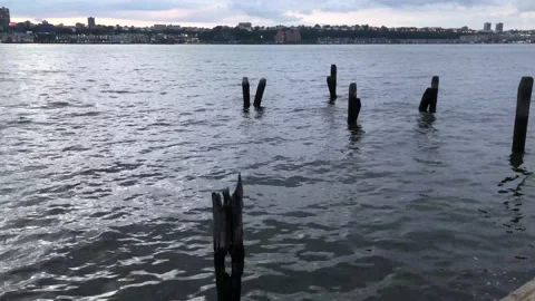 Flowing river on a grey day under big clouds Video stock 164541489