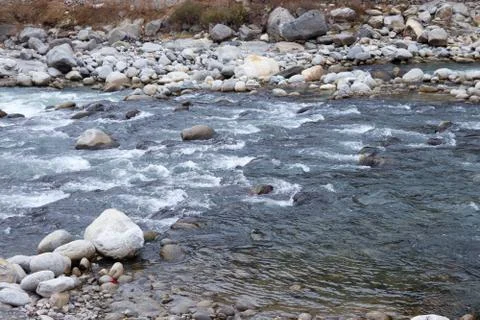 Flowing river having rocks in the river Fotos de archivo