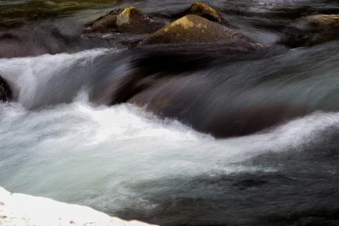 Flowing river having rocks in the river Fotos de archivo