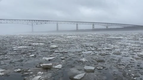Flowing River Ice in Front of Bridge Stock Footage 265112081