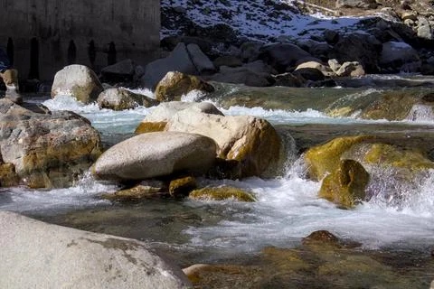 Flowing River Rapids with Rocks in Sunlit Landscape Stock Photos
