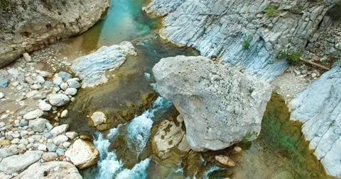 Flowing River, Small Waterfall and Big Rock 4k Aerial View Stock Footage 148351519