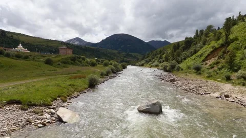 Flowing river stream through the mountains at Zeba village Stock Footage 283602194