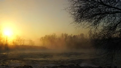 Flowing river with sun and fog Stock Footage