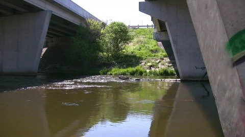 Flowing river under a concrete bridge Stock Footage 661334