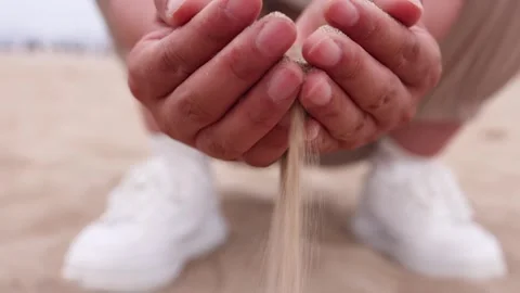 The flowing sand that can't hold it slip away from the fingertips Stock Footage 288272339