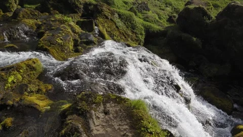 Flowing Stream and Small Waterfall over Mossy Rocks in Iceland Stock Footage 339637000
