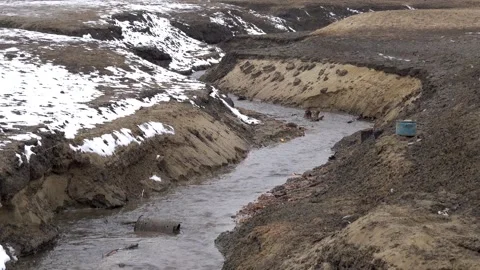 A flowing stream at the very bottom of Lake Domaa with a lack of water Stock Footage 303247452